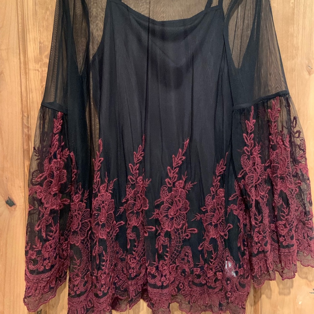 Sheer with bell sleeves. Embroidered flowers.